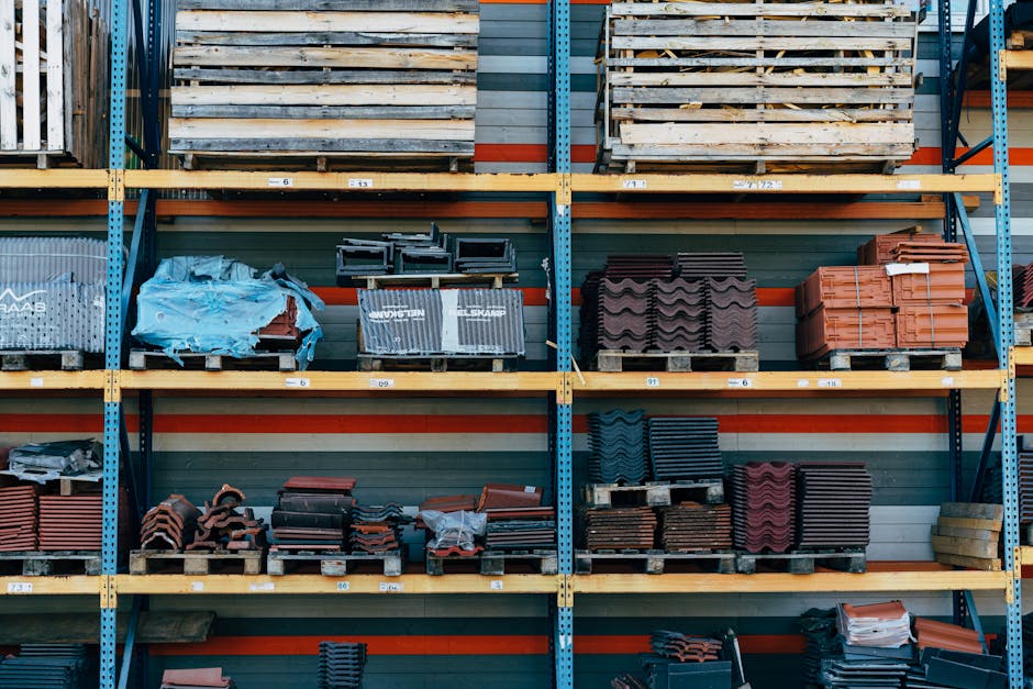 Shelves filled with construction materials like tiles and wood pallets in a ware